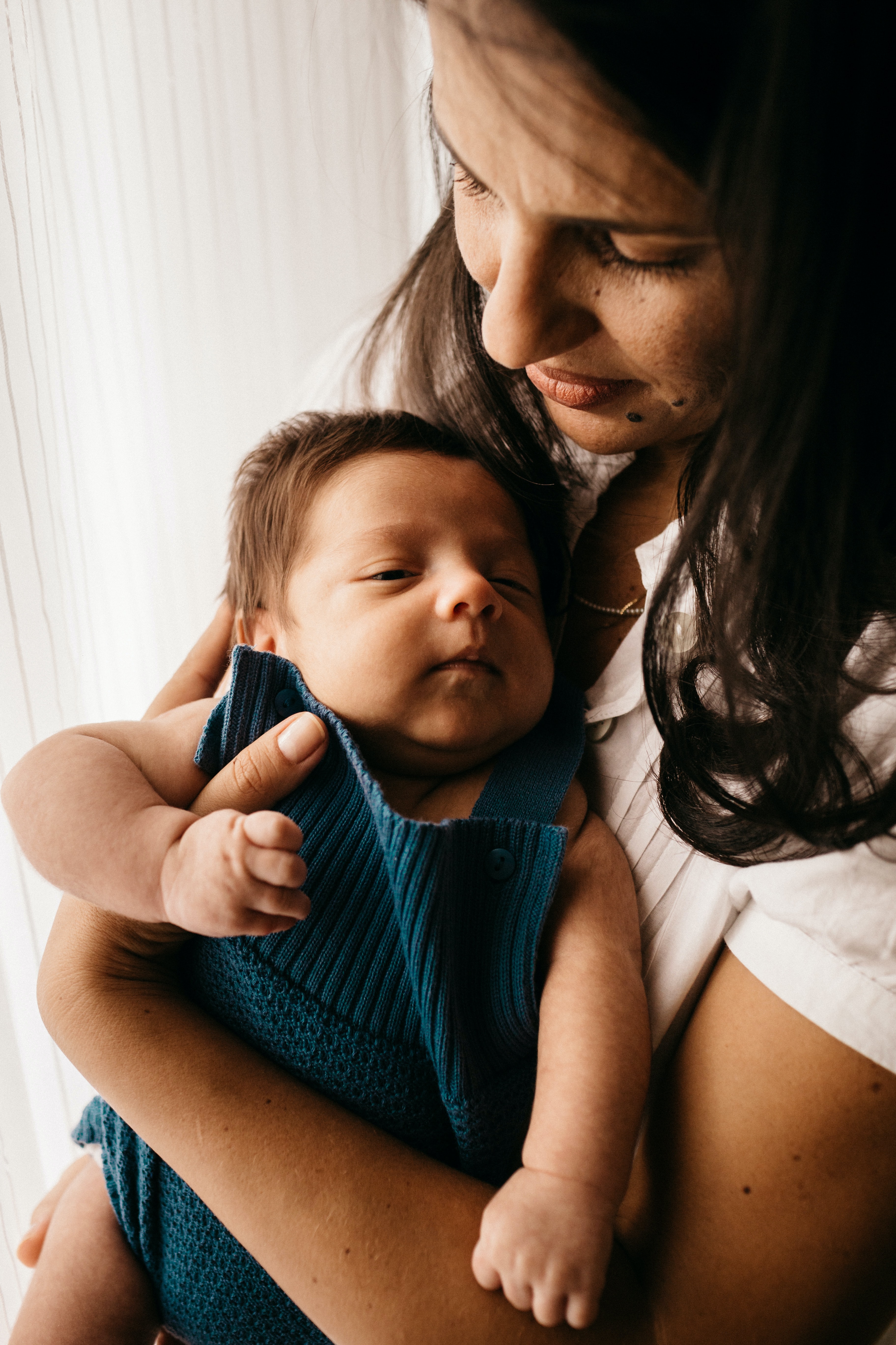 woman holding baby in front carrier