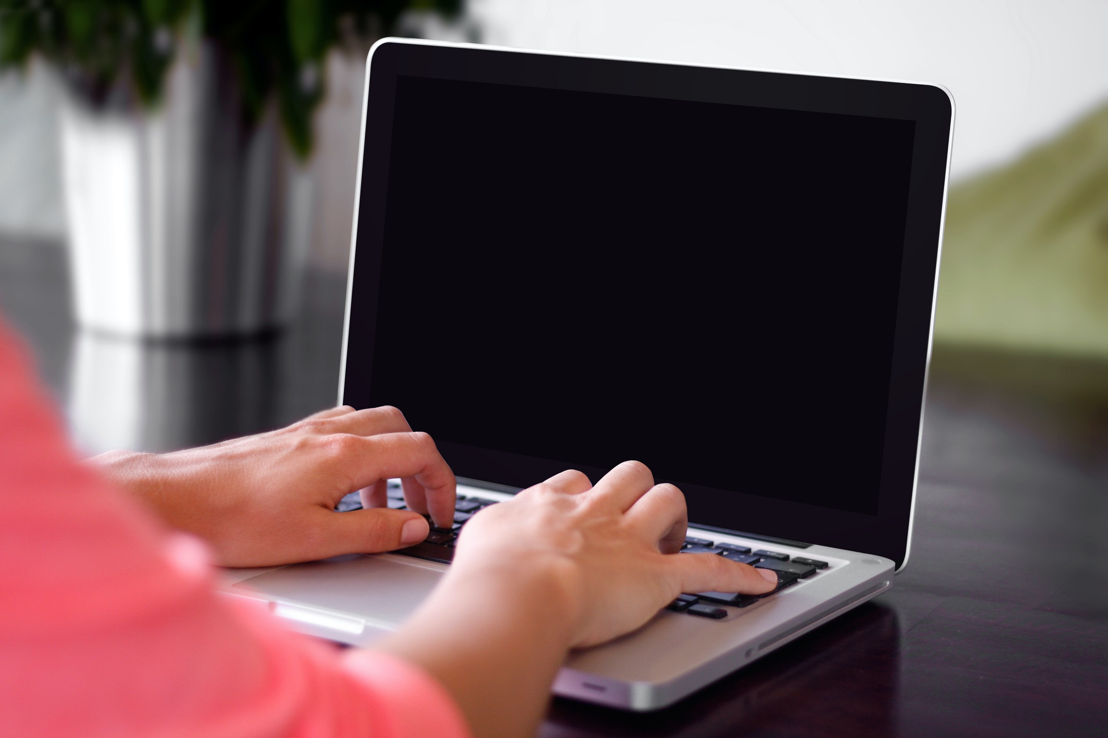 person typing on a laptop