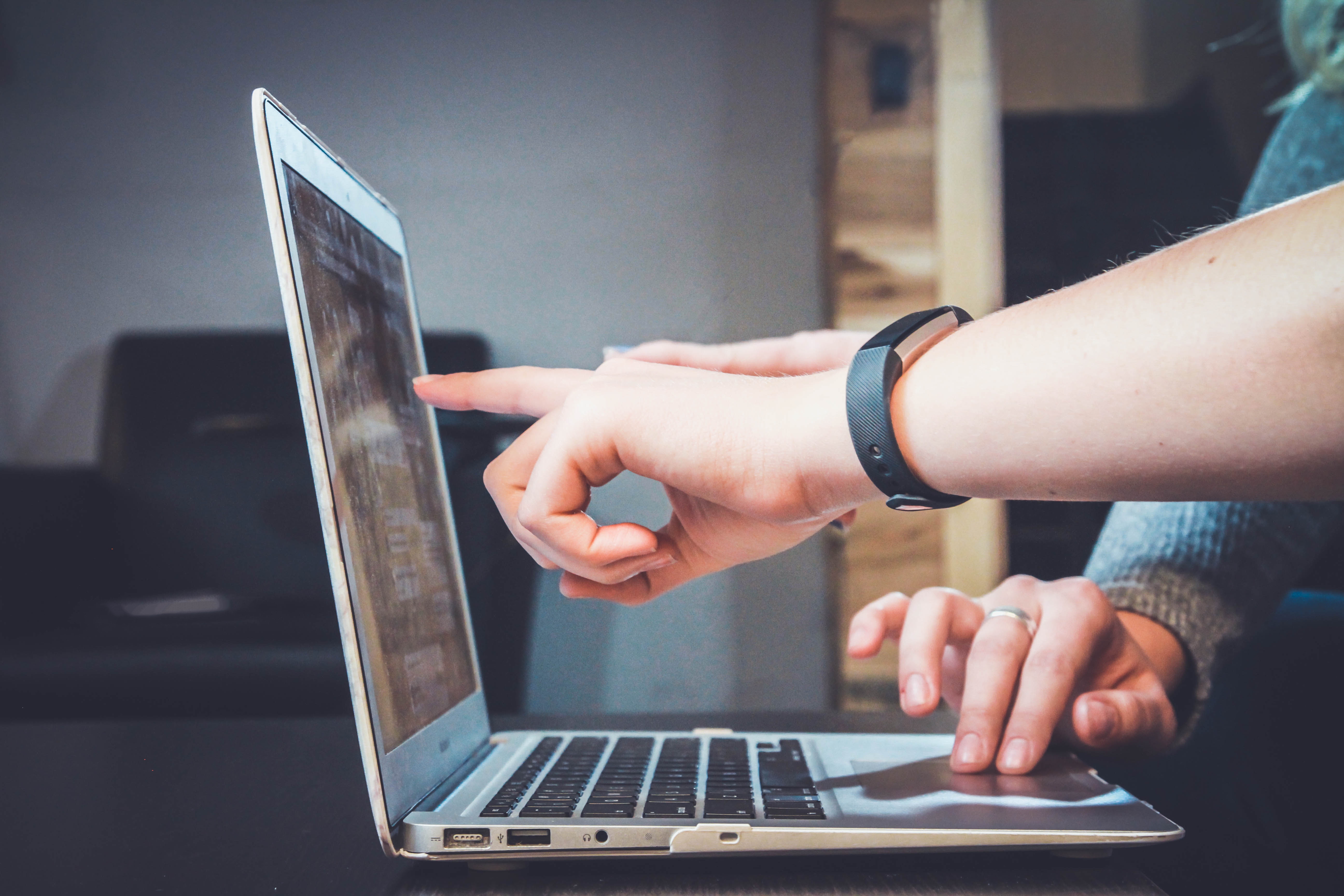 man pointing at a laptop