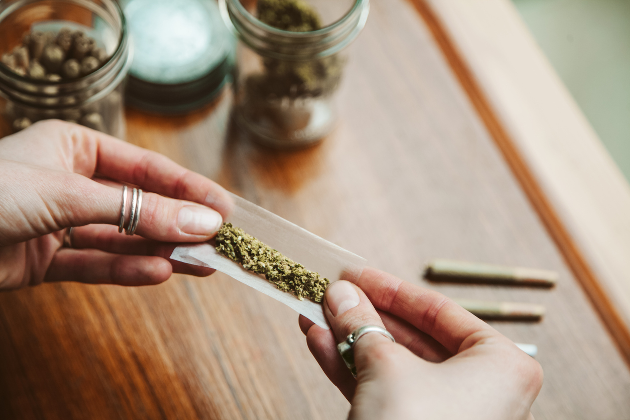 woman rolling cannabis